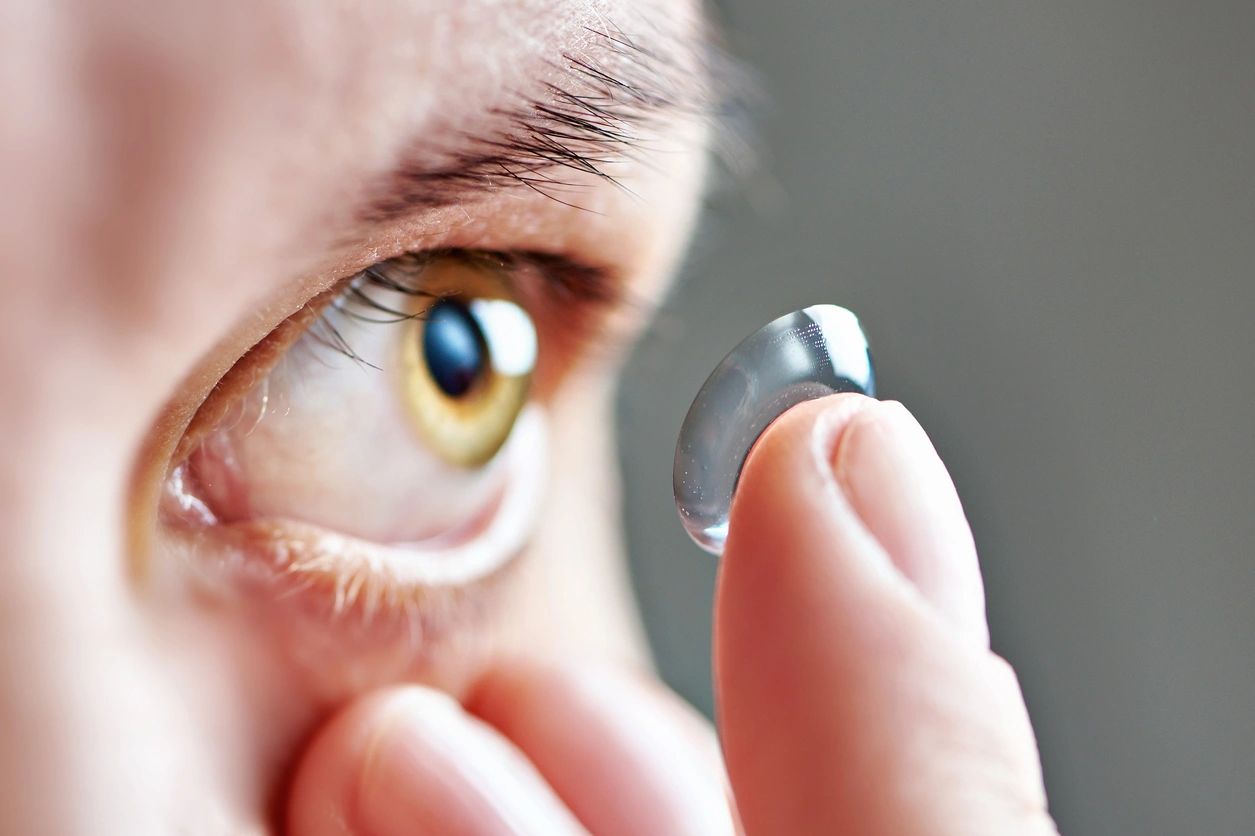 a person putting on a contact lens